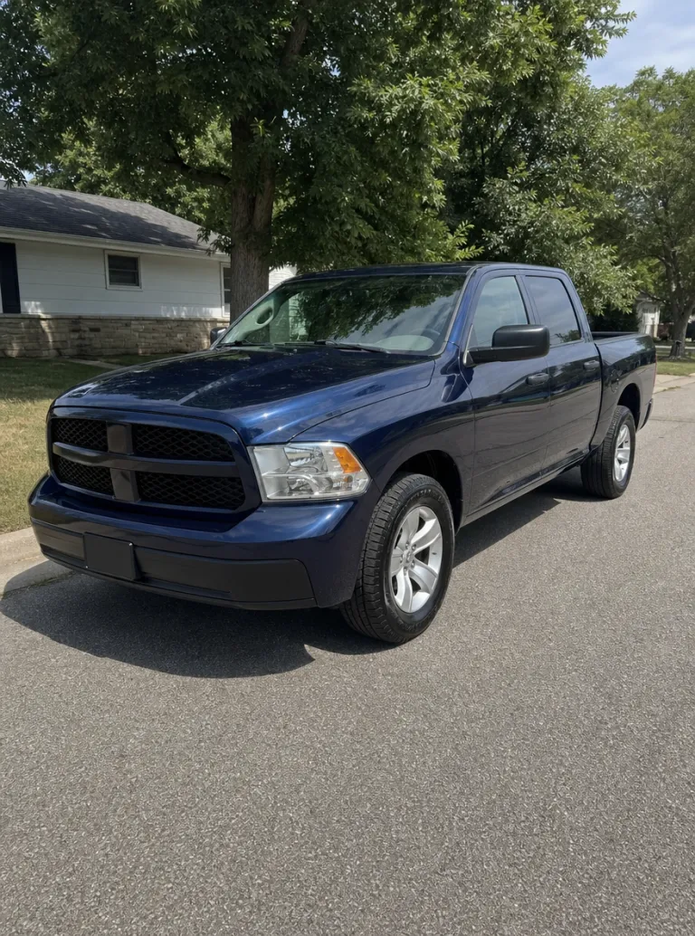 Sample photo: a dark-blue pickup truck parked on a quiet street in daylight, seen from the front three-quarter, the whole truck in frame