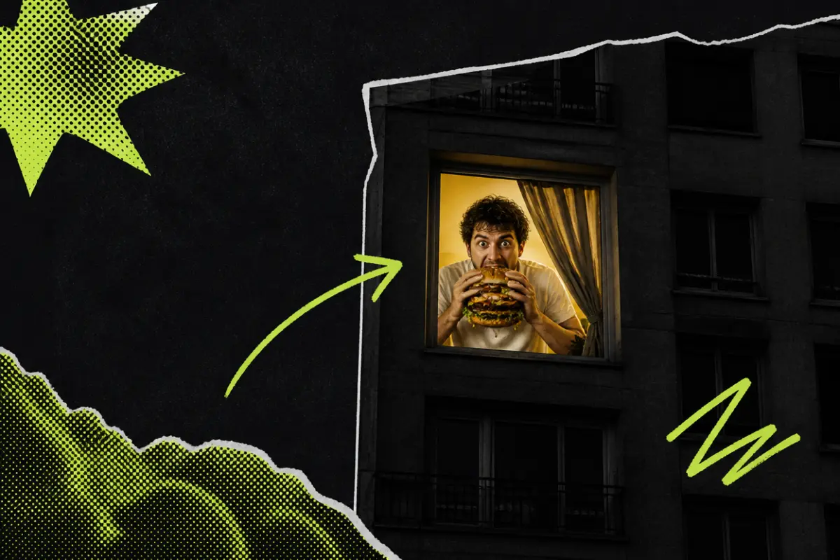 Collage: an apartment building at night with one lit window where a man bites into a huge burger and stares out